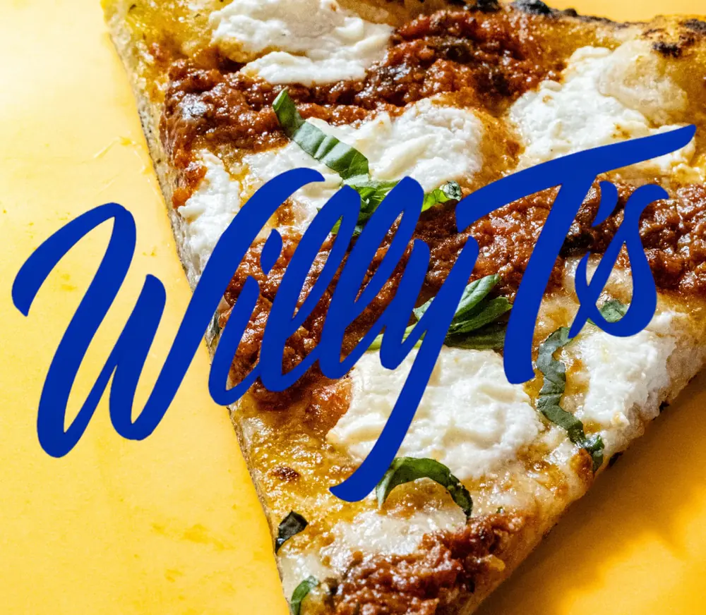 A slice of Willy T's pizza on yellow